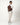 man carrying cognac leather backpack over shoulder