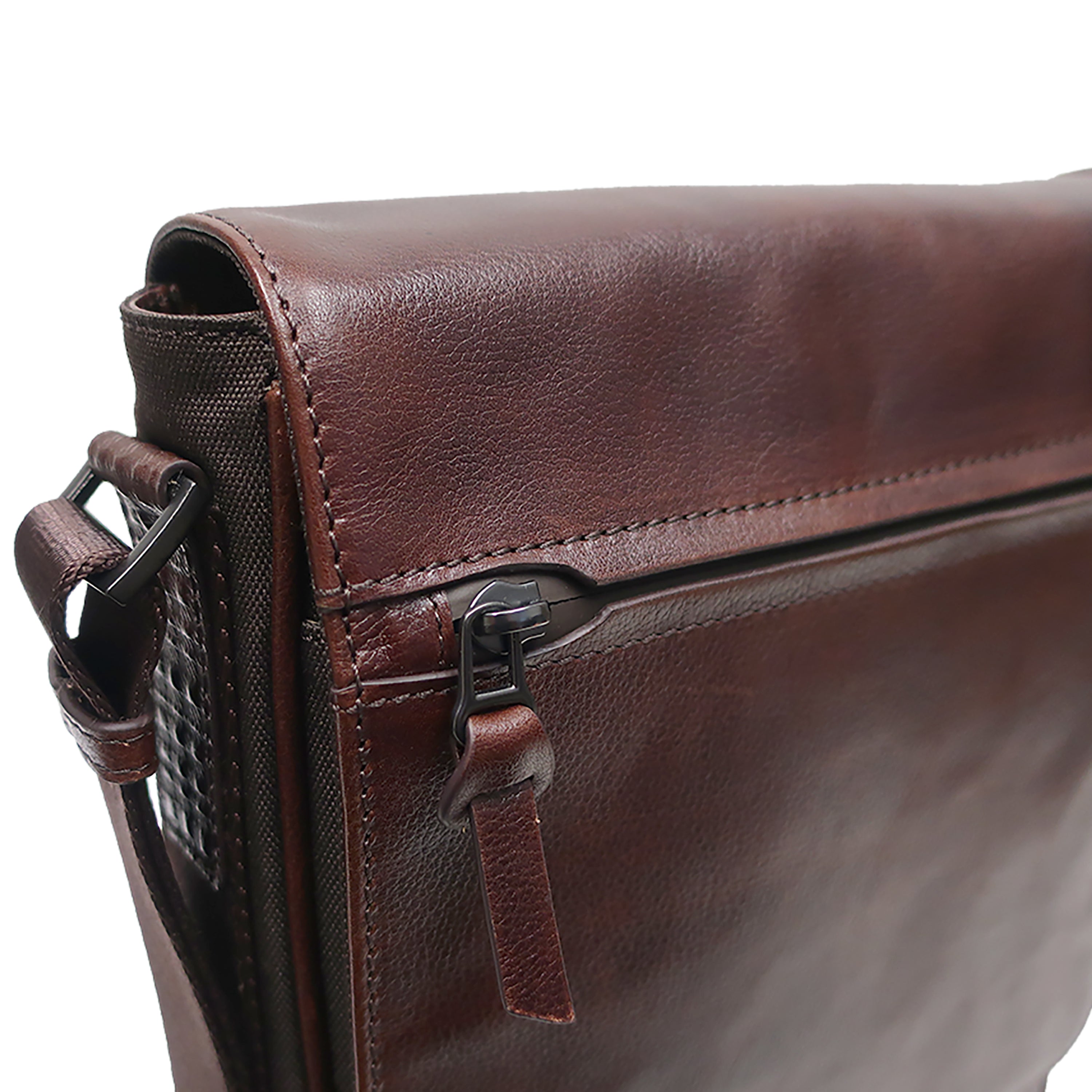 a close up of a brown leather bag on a white background