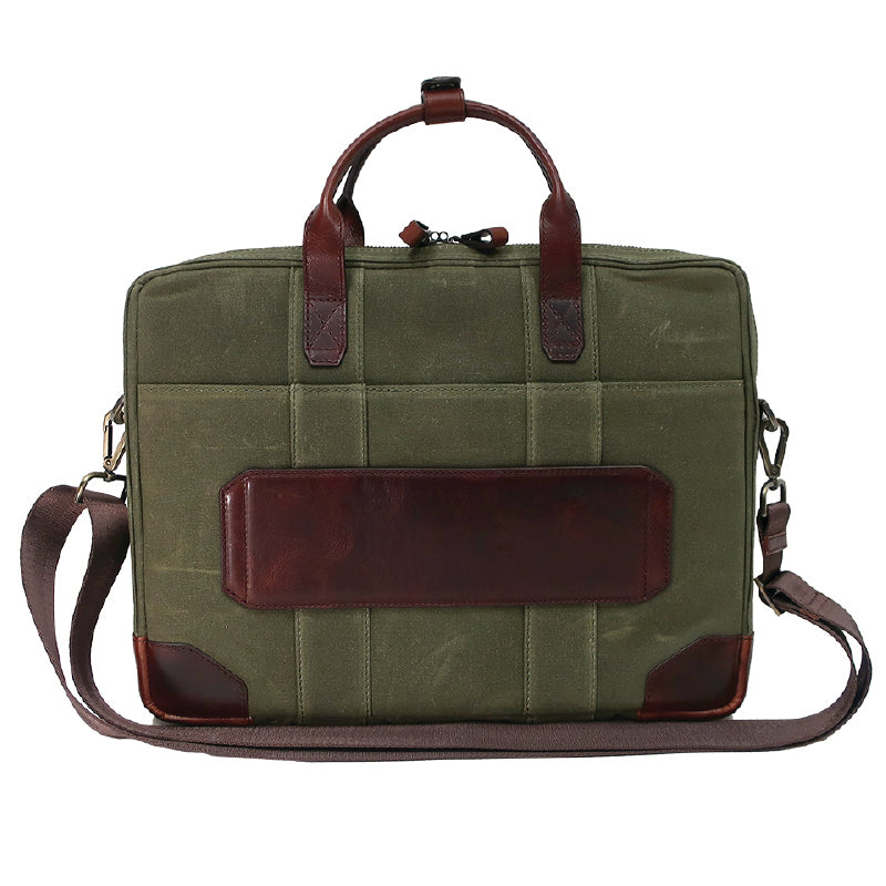 backside view of green and brown bag with a brown handle